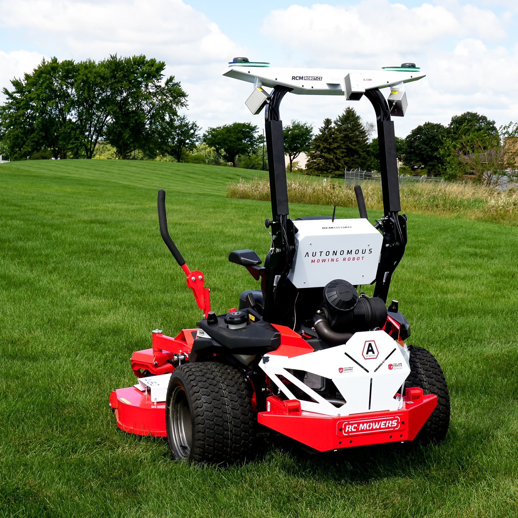 autonomous mowing robot mowing autonomously with a self driving commercial mower