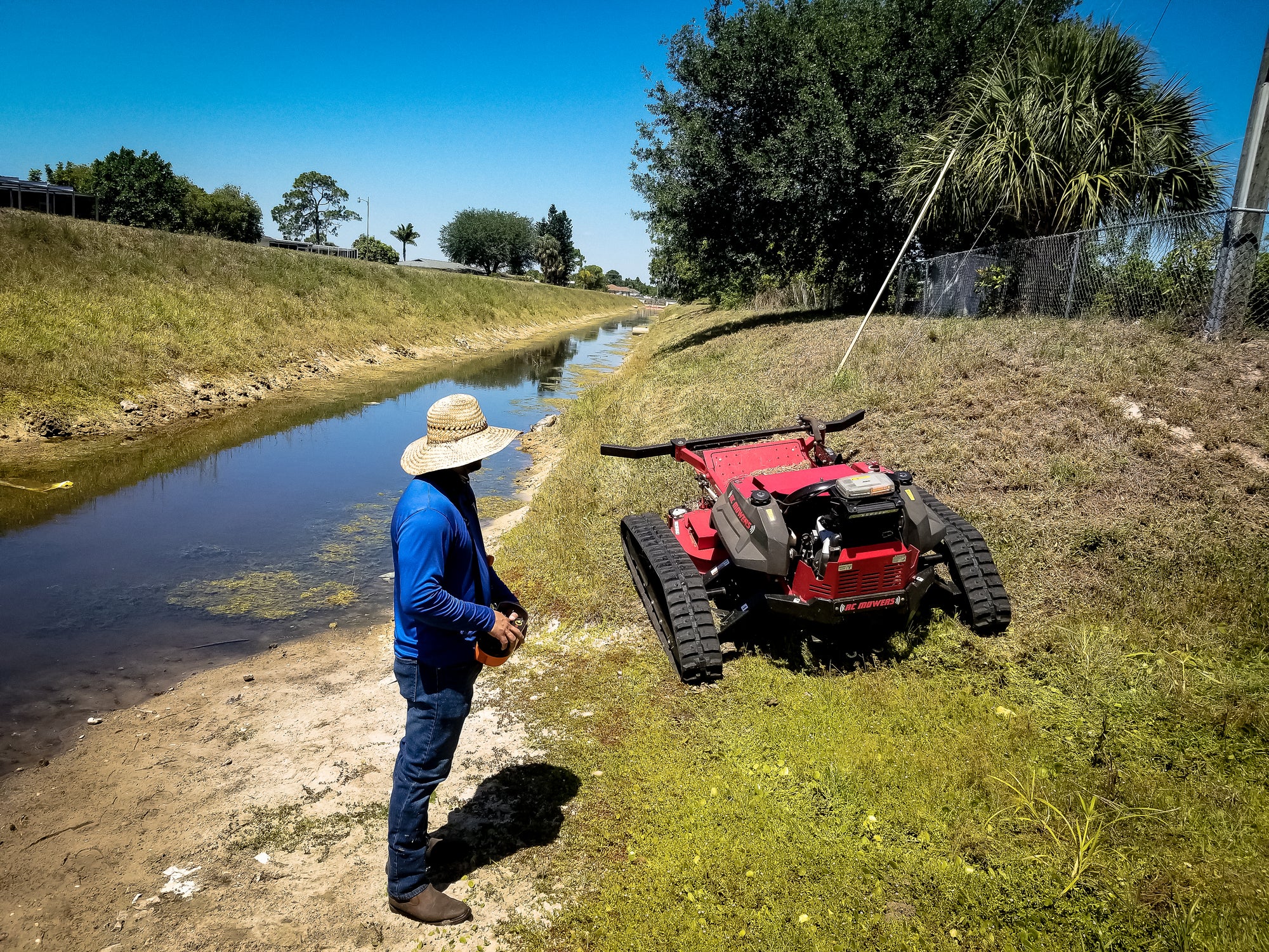 remote control mower on a steep canal