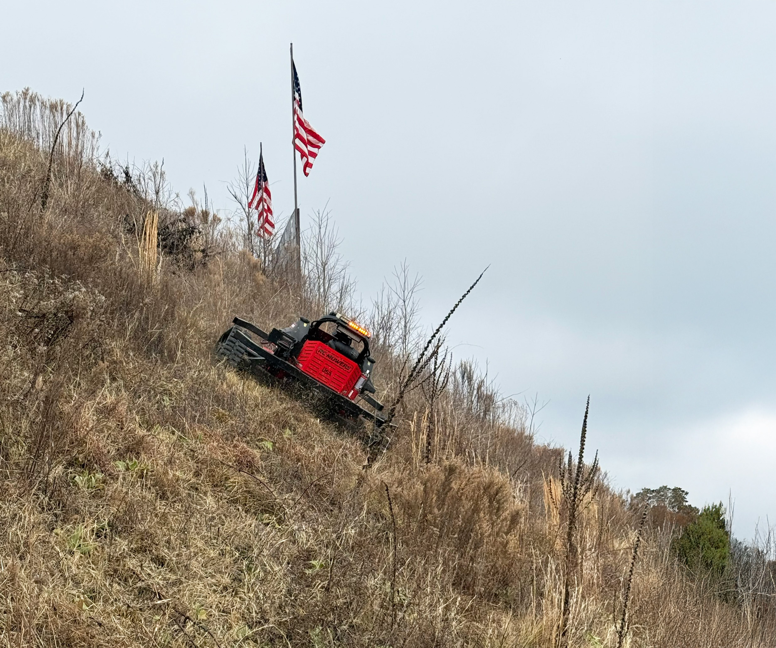 R Series machine on hill with American flag in background